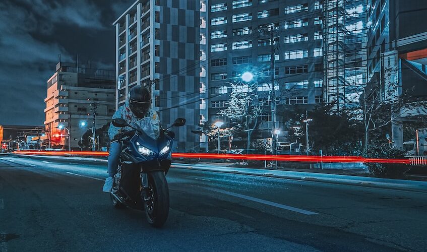 a person riding a motorcycle on a street