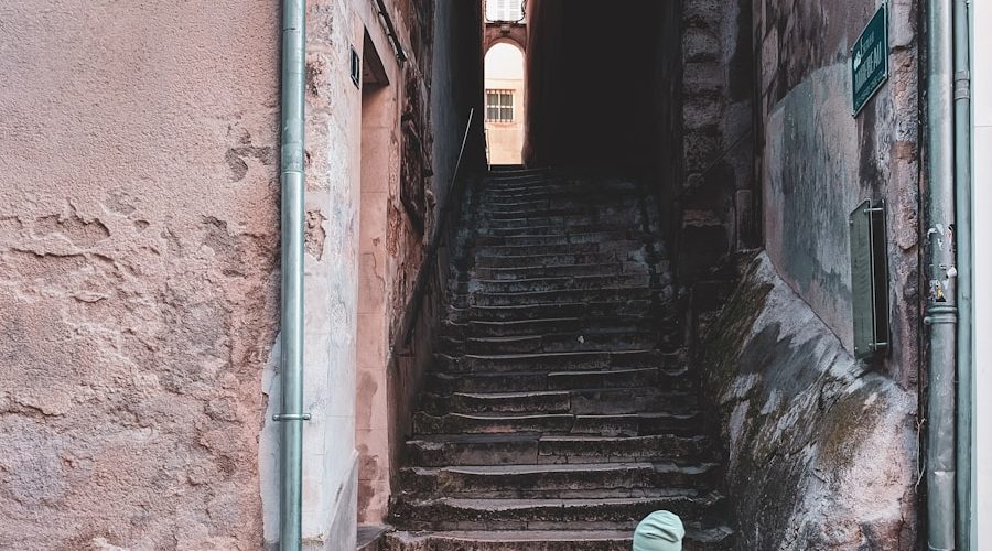 person in black and white dress walking on gray concrete stairs